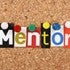 The word Mentor in magazine letters on a notice board