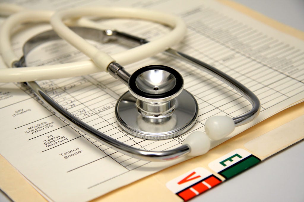 Photo showing stethoscope and medical records 