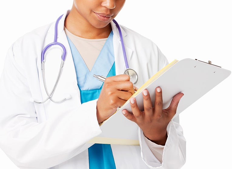 Midsection of African American female doctor writing down prognosis. Isolated on white.