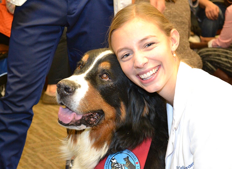 UVA medical student hugging dog