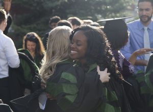 Two students hugging to celebrate this momentous occasion.