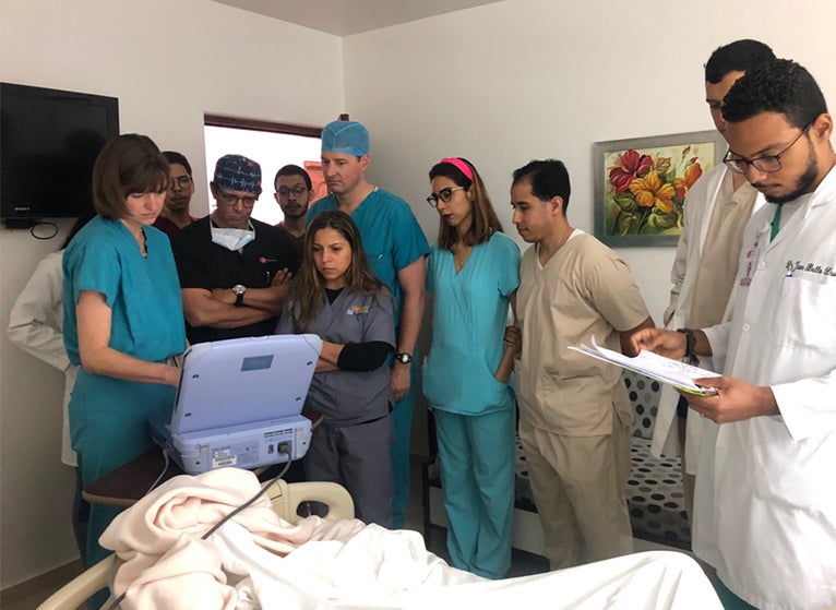 residents and doctors in patients room