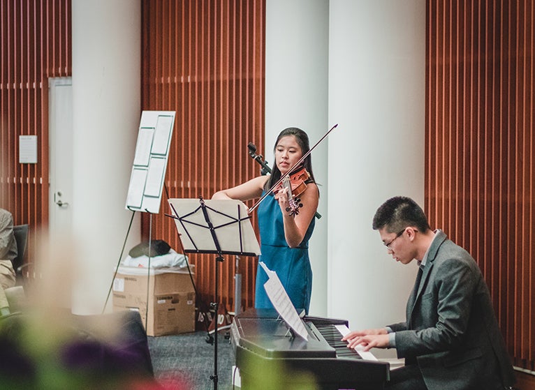 Photo: UVA Medical Student playing violin.