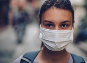 Woman wearing a mask to protect herself from Coronavirus