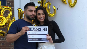 UVA School of Medicine, MD Program Match Day Celebrations 2022 couple showing match results cards