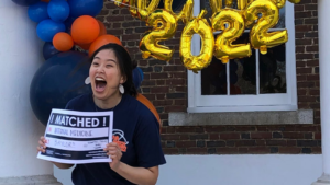 UVA School of Medicine, MD Program Match Day Celebrations 2022 excited female showing match results cards
