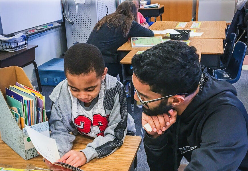 Man and boy reading together