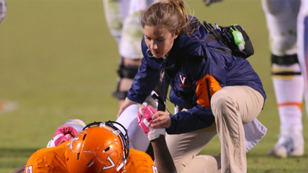 Cat Donahue attends to injured UVA football player