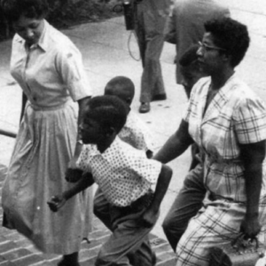 Black women and children walking up steps