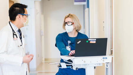 Doctor and nurse consultation in hallway