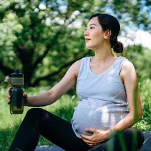 Pregnant woman with water bottle