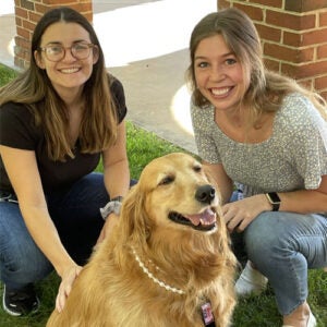 two girls and a dog