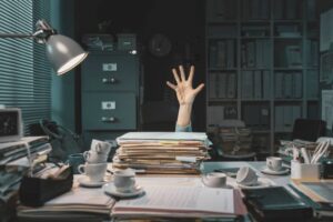 Files on Desk with Hand