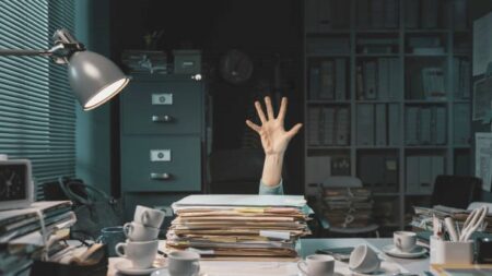 Files on Desk with Hand