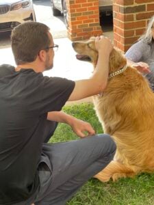 student petting dog