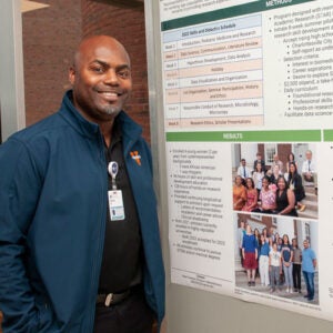 Person standing at poster presentation