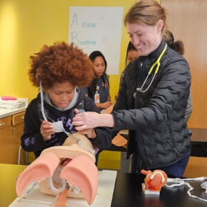 Student doing hands on simulation of plastic surgery procedure.