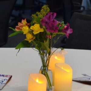 Flowers on a table with lit candles