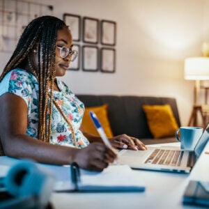 Black woman at computer doing online course