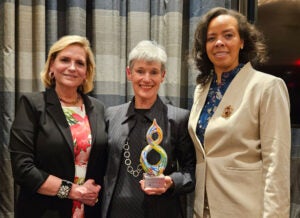 Dr. Pollart ( in center of 2 women) receiving an award
