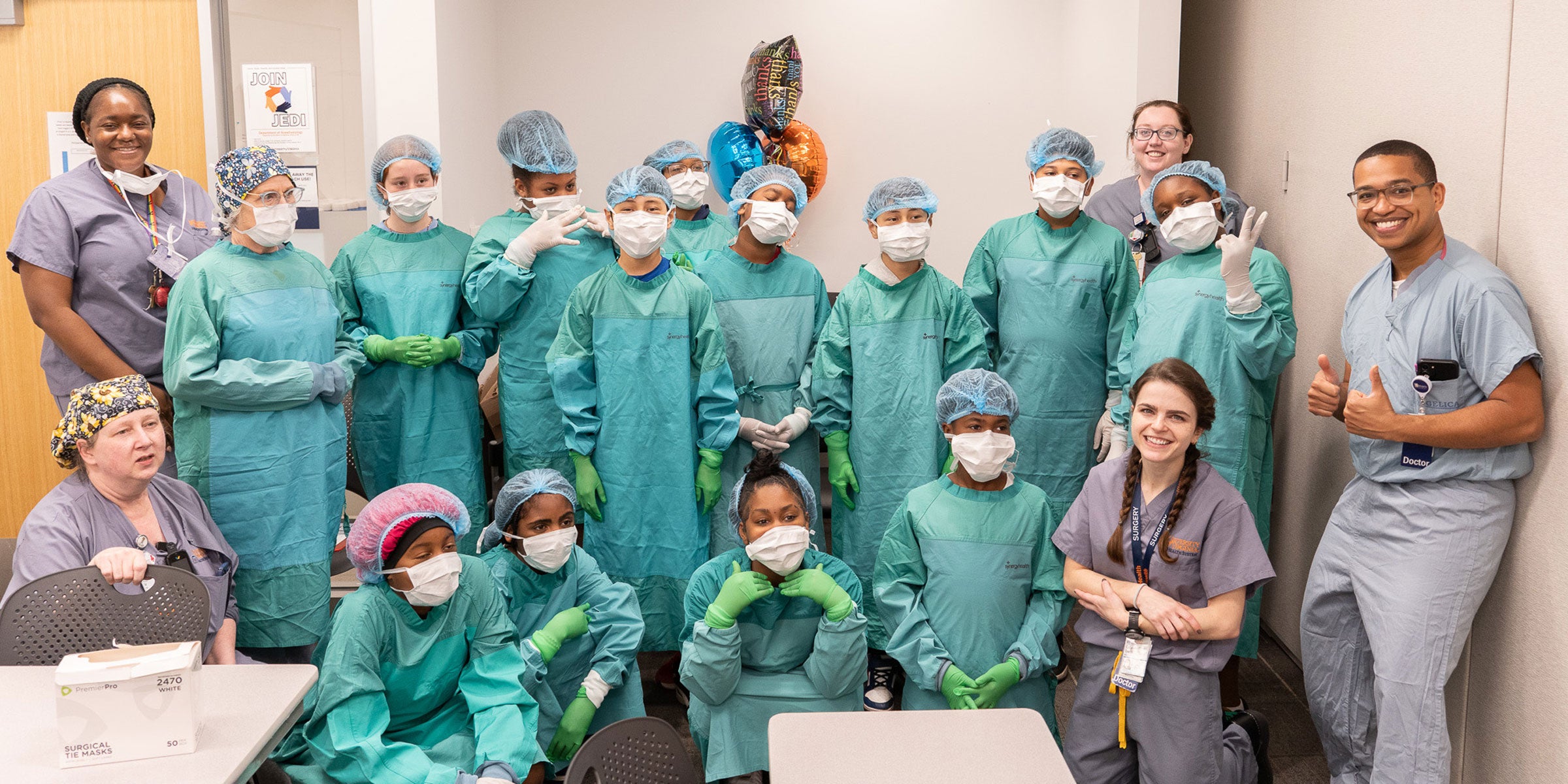 The entire group decked out in their surgical garb thanks to the operating room nurses.