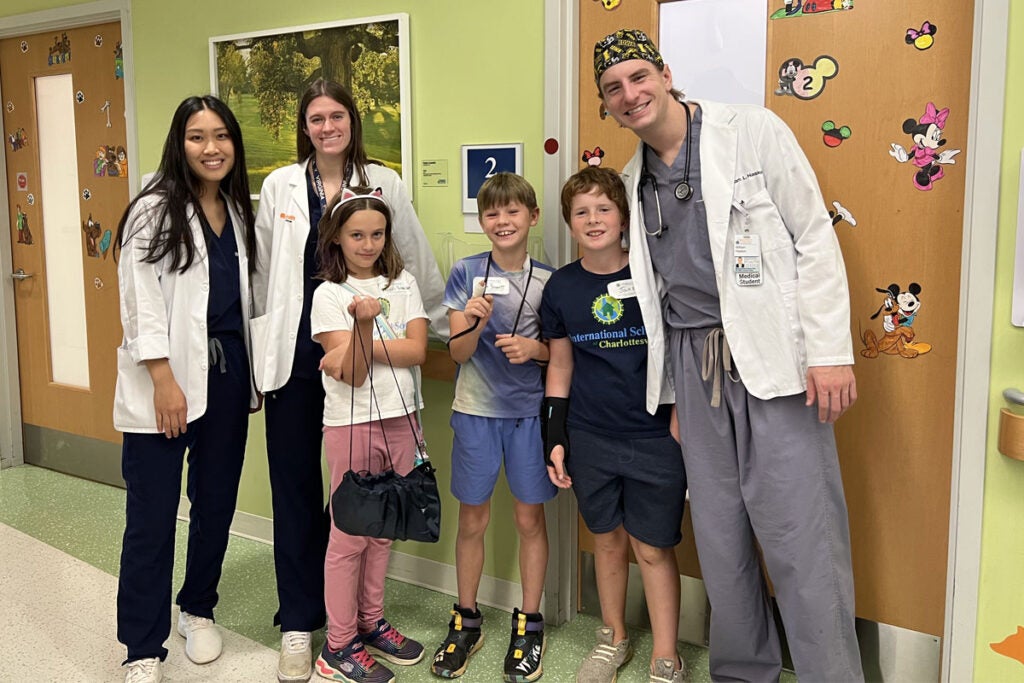 Alpha Omega med students with elementary kids