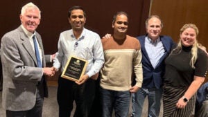 Director of the Office of Research Core Administration Jay Fox, PhD (left) presents the Core of the Year award to team members of the Radiochemistry Core.