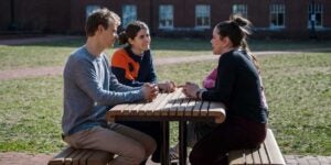 People sitting at picnic table.