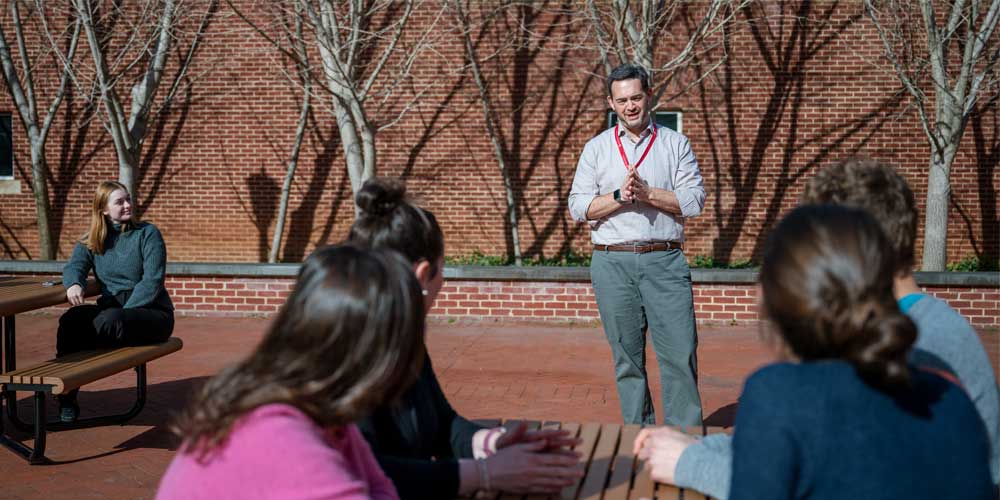 Brant Isakson and researchers at picnic tables