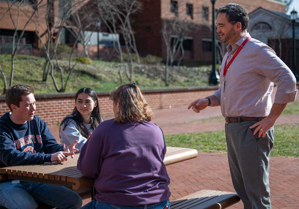 Brant Isakson and researchers at picnic tables