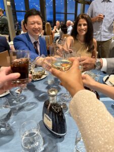 Dr. Josh Li, Sandhya Chhabra, and others toast UVA Orthopaedics at the Alumni Conference dinner.