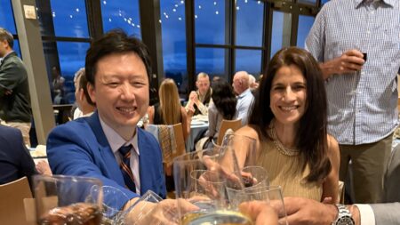 Dr. Josh Li, Sandhya Chhabra, and others toast UVA Orthopaedics at the Alumni Conference dinner.