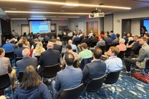 Dr. Bobby Chhabra kicks off the conference Friday morning to a packed Wang Conference Room.