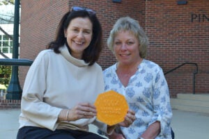 Anja Bielinsky and Nancy Rush with their 100% department certified plaque.