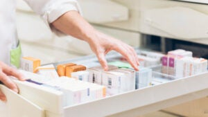 Pharmacist selecting drugs from a drawer