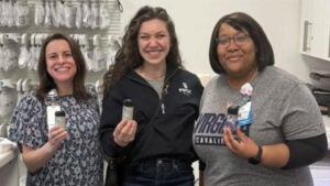 Pharmacy techs with recycled paper pill bottles