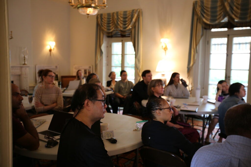 people sitting at tables writing retreat