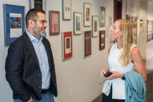Francesco Viola and Shayn Peirce-Cottler, friends since their days as Ph.D. students in the Department of Biomedical Engineering, catch up in the hallway at BME building MR5. Viola is the chief technology officer at HemoSonics, the company he co-founded at UVA, while Peirce-Cottler is a professor and chair of the department. (Photo by Matt Cosner, UVA Engineering)