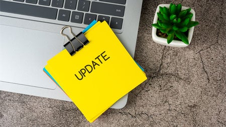 Laptop with sticky note that says 