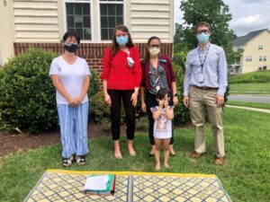 UVA residents with a family outside with masks on for COVID.