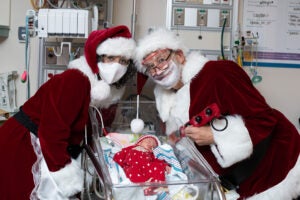 santa and mrs claus pose with nicu babies at christmas