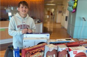 Luke Post with toys for the UVA Children's Battle Building Toy Closet 