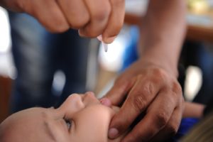 Administering bi-valent oral polio vaccine one drop at a time to children